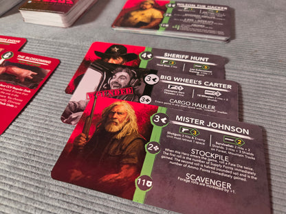 Collection of cards featuring characters and text on a gray surface