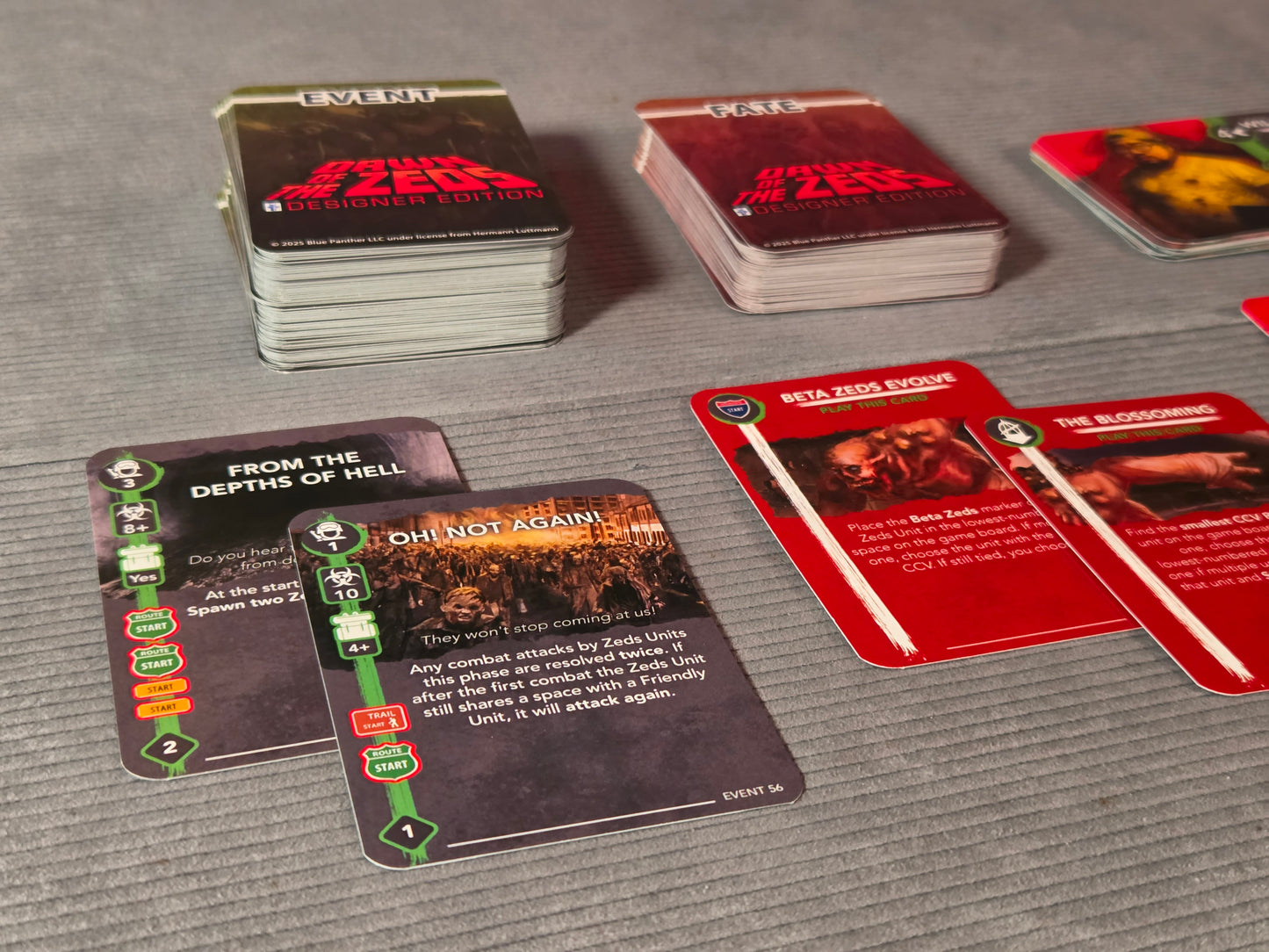 Card game with various cards on a gray surface