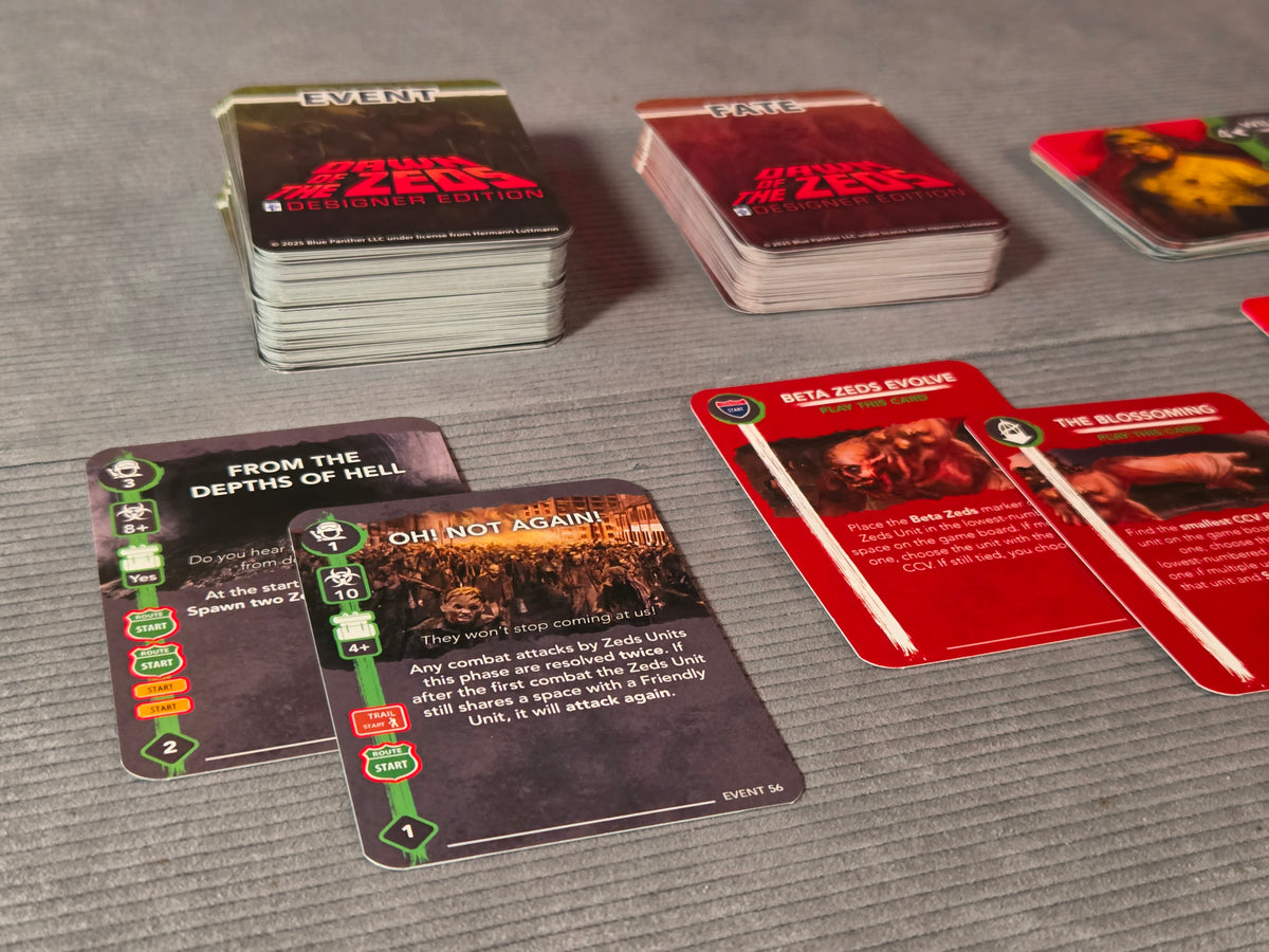 Card game with various cards on a gray surface