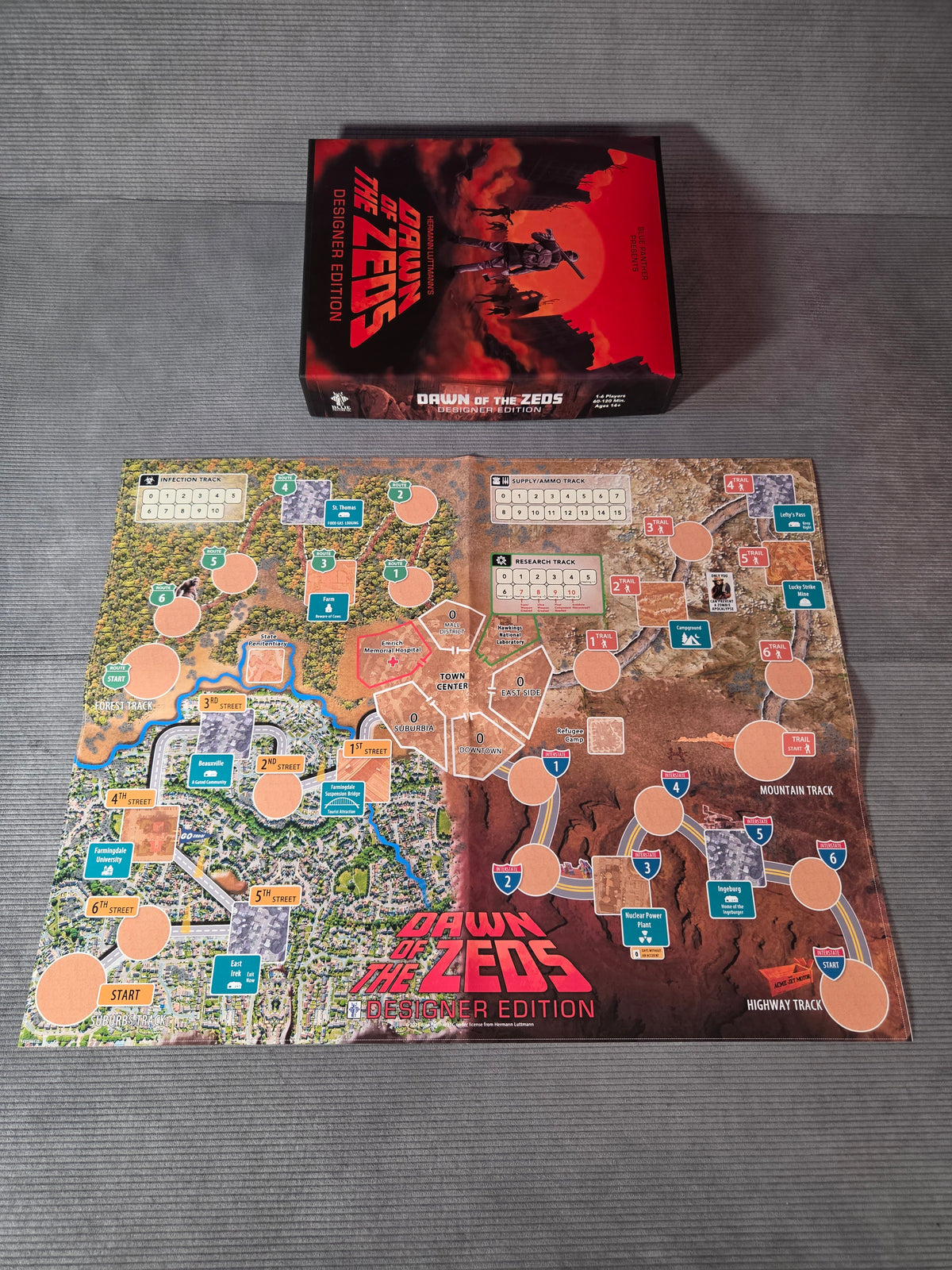 Board game packaging for 'Dawn of the Zeo' on a gray surface