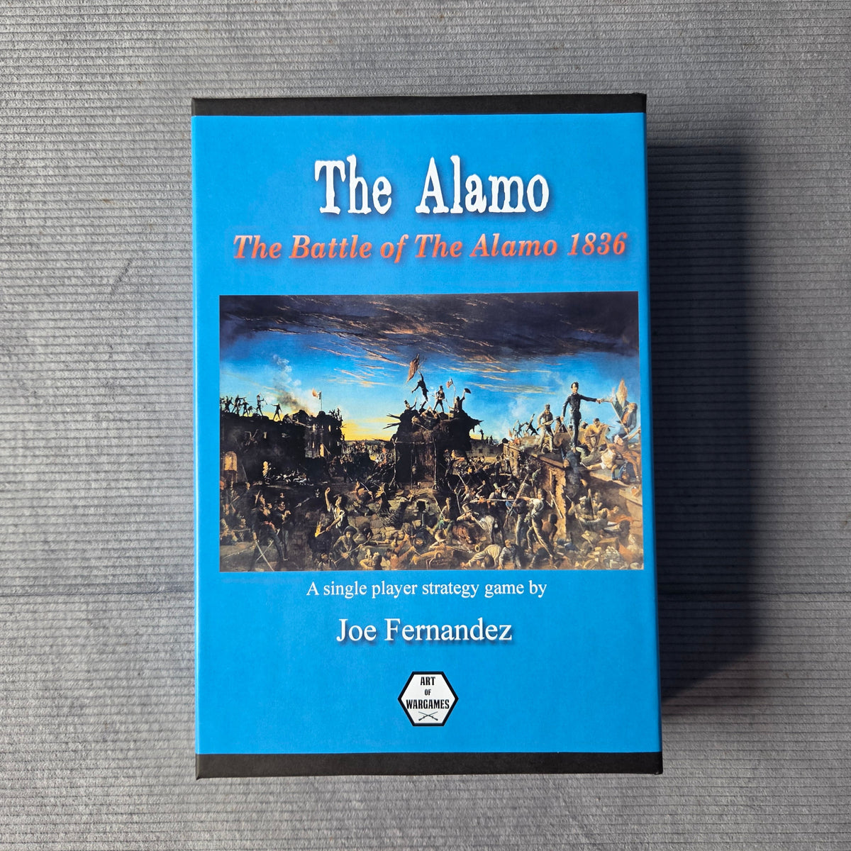 Game titled 'The Alamo' on a gray surface