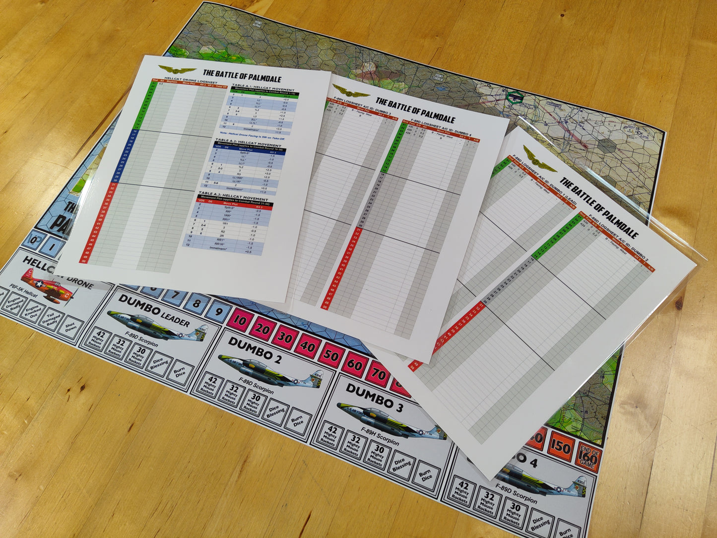 Board game components including cards and a map on a wooden surface
