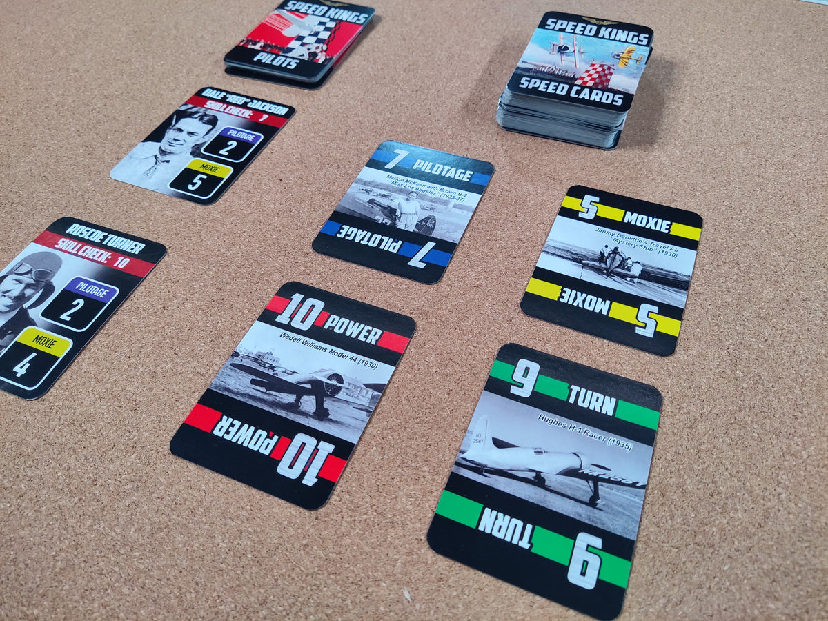 Collection of racing-themed cards on a textured surface