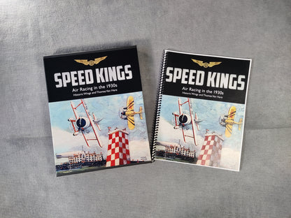 Two items related to Speed Kings, a game box and a rulebook, on a gray surface.