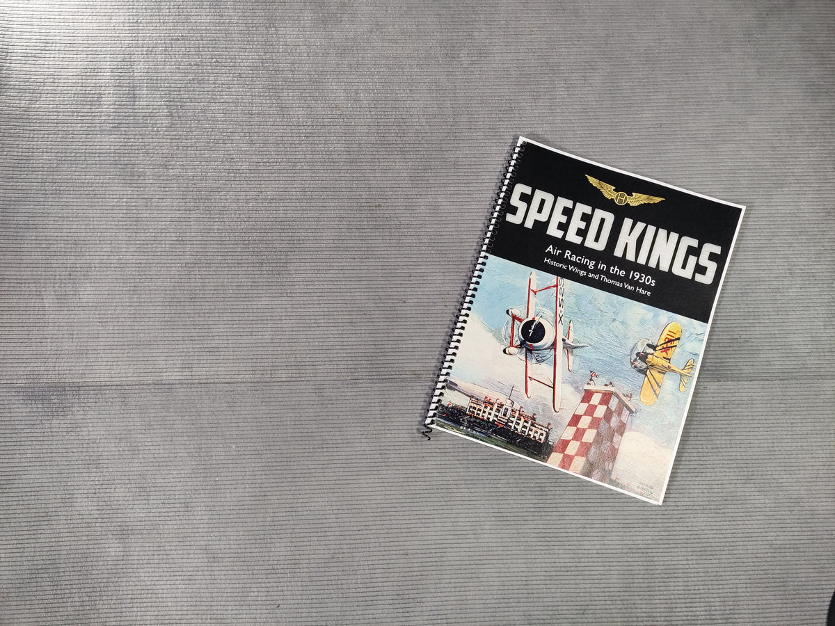 Notebook titled 'Speed Kings' on a textured gray surface