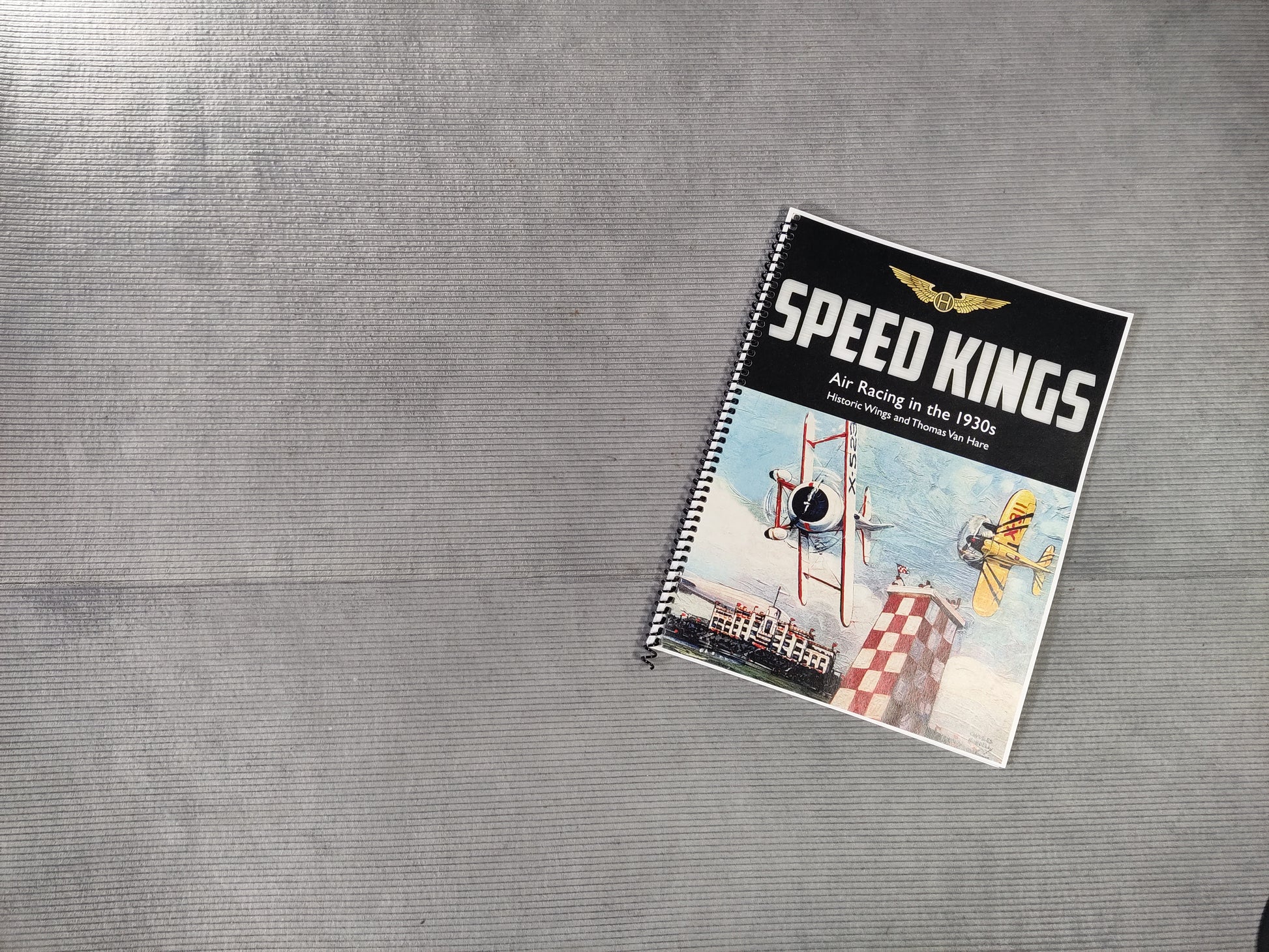 Notebook titled 'Speed Kings' on a textured gray surface