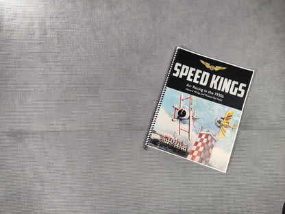 Notebook titled 'Speed Kings' on a textured gray surface