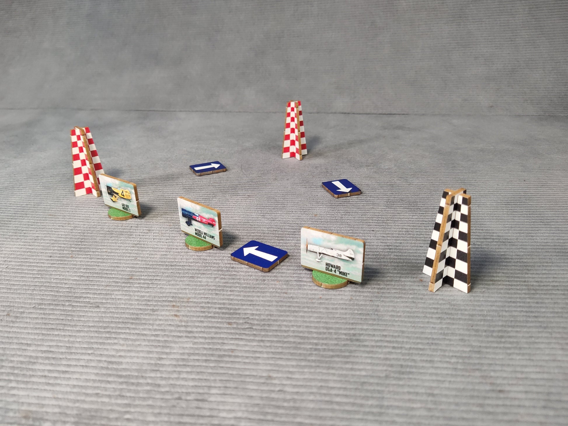 Set of miniature race track obstacles on a gray surface